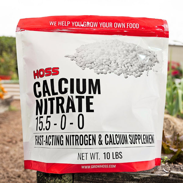 Bag of HOSS Calcium Nitrate fertilizer with a garden background